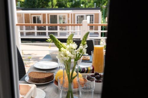 a table with food and a vase of flowers on it at Campeggio Europa Silvella in San Felice del Benaco