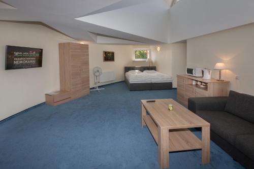 En eller flere senge i et værelse på Tauras Center Hotel