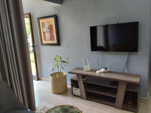 a living room with a flat screen tv on the wall at Rena Apartment in Lilongwe