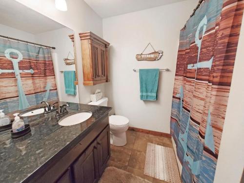 a bathroom with a sink and a toilet at Bridges Bay Vacation Cabin 115 in Arnolds Park