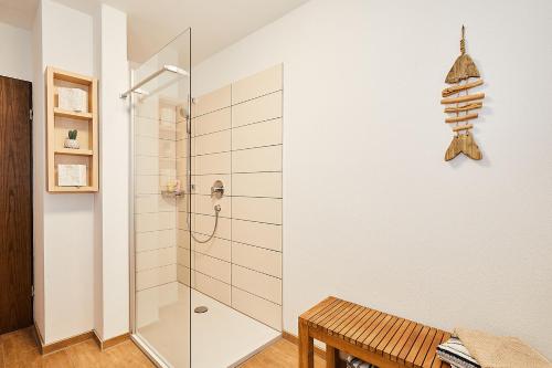 a bathroom with a shower and a bench at Alpen-Chalet Benzeck in Reit im Winkl