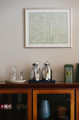 a shelf with jars on top of a wooden cabinet at Rye115 Hotel in Copenhagen
