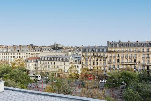 a view of a city from the roof of a building at Residence Le Marais by Studio prestige in Paris