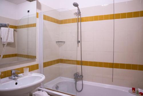 a bathroom with a shower and a sink and a tub at Relais Villa Pomela in Novi Ligure