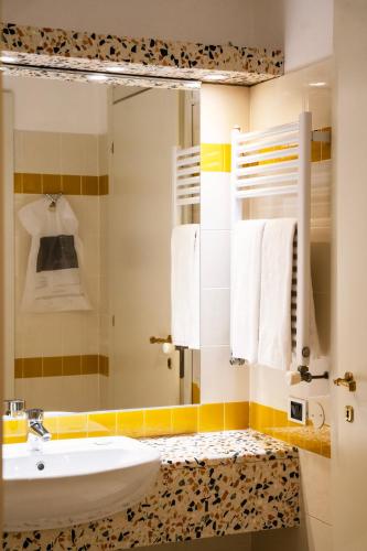 a bathroom with a sink and a mirror at Relais Villa Pomela in Novi Ligure