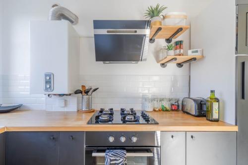 a kitchen with a stove and a counter top at Superbe appart chic, hyper centre, vue château, Parking inclus in Caen