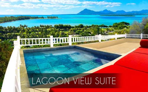 a swimming pool with a view of the ocean at Kozy Le Morne in Le Morne