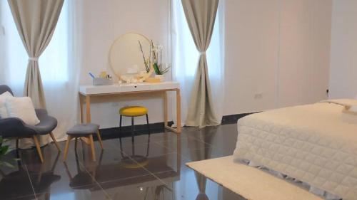 a bedroom with a table and two stools and a mirror at Luxury Loft Apartment in Kuwait