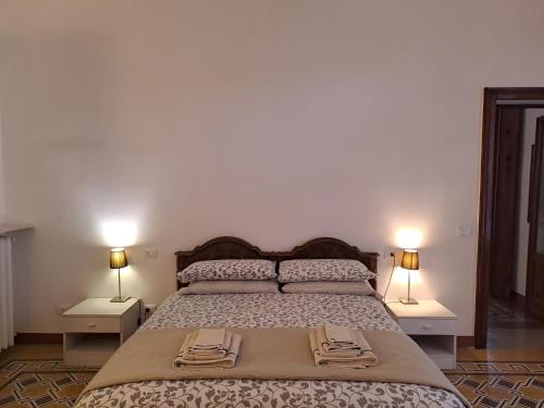 a bedroom with a bed with two towels on it at B&B Alice in Cremona