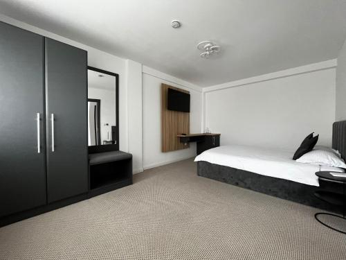 Ένα ή περισσότερα κρεβάτια σε δωμάτιο στο Belvedere Restaurant & Rooms