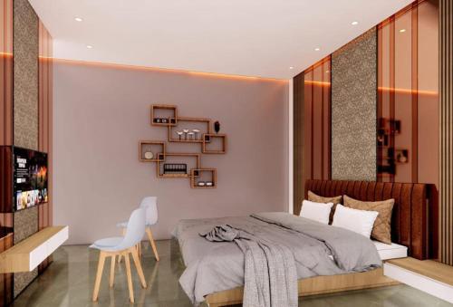 a bedroom with a bed and a table and a chair at Hotel The Mint Nanded in Nānded