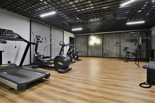 a gym with several treadmills and exercise bikes at Śląska Studio with Parking & Gym Business District Gdańsk by Renters in Gdańsk
