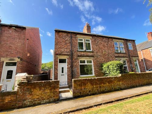 an old brick house with a brick wall at Rosie's Cottage - Beamish in Beamish