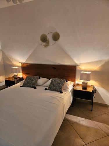 a bedroom with a large white bed with two lamps at 215 addaura luxury room in Palermo