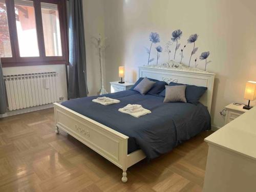 um quarto com uma cama grande e um edredão azul em MarcoPoloAirport-2 camere da letto-Wifi-Netflix-15' da Venezia em Tessera