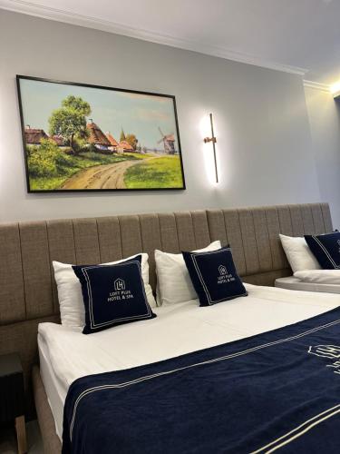 een slaapkamer met 2 bedden en een kruis aan de muur bij Loft Park Hotel's in Arnavutköy