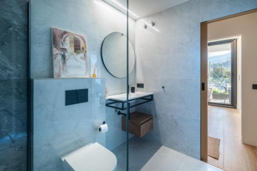 a bathroom with a toilet and a glass shower at Riverview apartamento en LLanes in Llanes