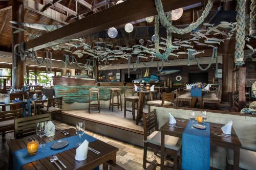 a restaurant with tables and chairs and a bar at Azul Beach Resort Riviera Cancun, Gourmet All Inclusive by Karisma in Puerto Morelos