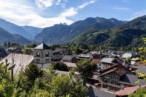 a small town in the mountains with a church at Studio Samoëns Septimontain 2/4 pers in Samoëns