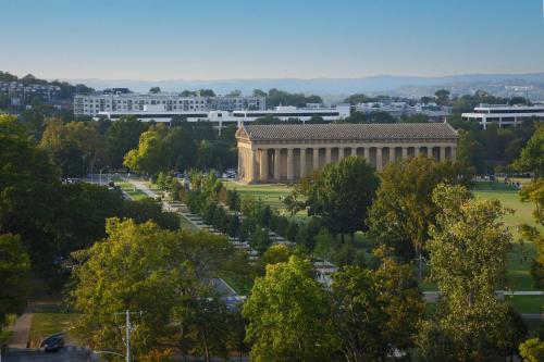 a building in a park with trees and buildings at Holiday Inn Nashville - Vanderbilt - Dwtn by IHG in Nashville