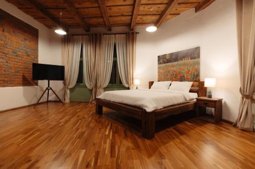 a bedroom with a bed and a painting on the wall at Old Town Casa 1901 in Baia Mare