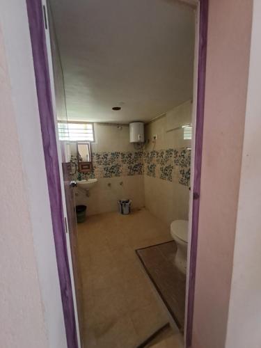 a bathroom with a toilet and a sink at The Circle in Auroville