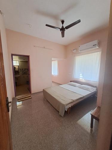 una camera con letto e ventilatore a soffitto di The Circle ad Auroville
