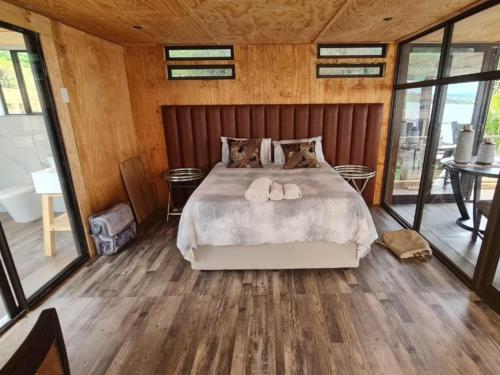 a bedroom with a bed with two slippers on it at Tshifaro Gardens in Thohoyandou