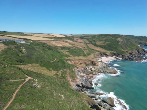 an aerial view of the ocean and coastline at Gara Rock in Salcombe