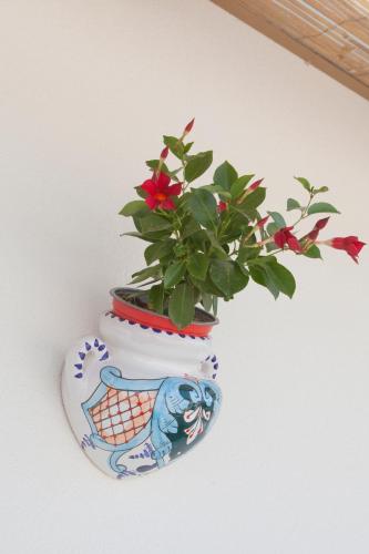 a blue and white vase with a plant in it at Casa Valerio in Conversano