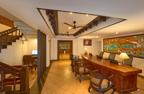 a living room with a long table and chairs at The Raviz Kadavu, Kozhikode in Kozhikode