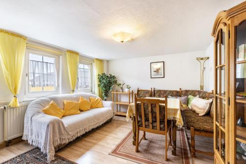 a living room with a couch and a table at Ferienwohnung Apfelbaum in Albstadt