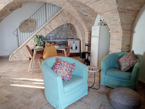 a living room with two chairs and a refrigerator at ANPEMO Casa Vacanze in Silvi Paese