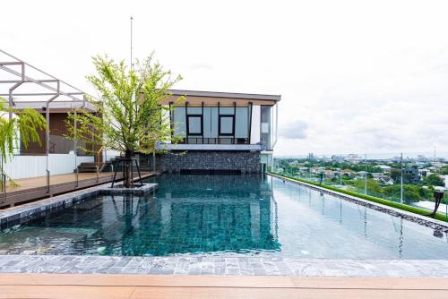 a swimming pool on the roof of a building at Frame Hotel Bangkok in Bangkok
