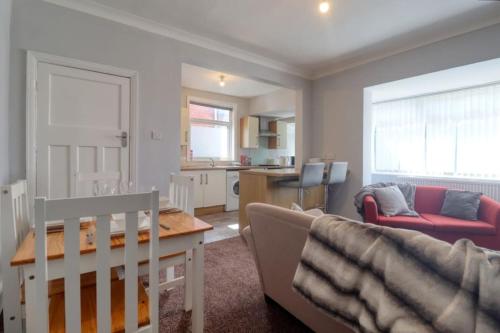 a living room with a couch and a table at Highfield House cosy 4 bedroom in Scunthorpe