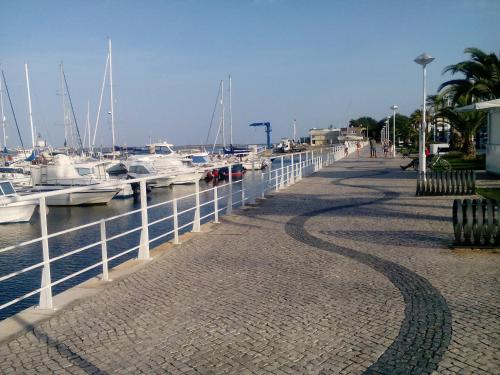 a walkway next to a marina with boats at Residência Matos Pereira in Vila Real de Santo António