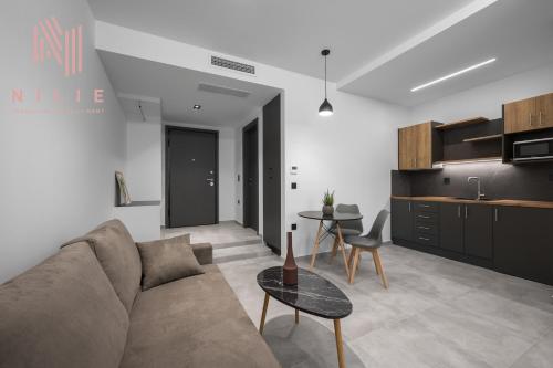 a living room with a couch and a table at Pantheon, Nilie Hospitality MGMT in Thessaloniki
