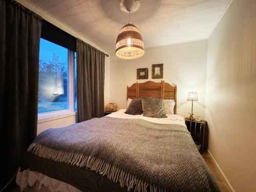 a bedroom with a large bed and a window at Cozy little cottage in the middle of Gotland near Visby in Visby