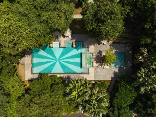 an overhead view of a swimming pool with a blue umbrella at Taj Usha Kiran Palace, Gwalior in Gwalior