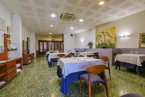 a dining room with tables and chairs in a room at Hotel Robert in La Pobla de Claramunt