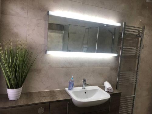 a bathroom with a sink and a mirror at 29 Comfort house 2 bedroom townhouse with parking in Scunthorpe