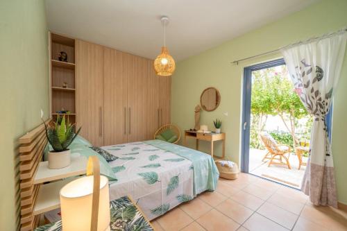 Schlafzimmer mit einem Bett und einer Glasschiebetür in der Unterkunft House Kochyli in Kefalonia