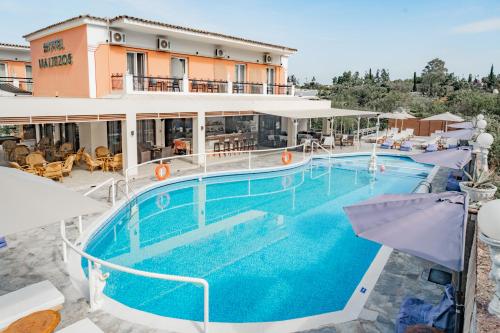 a large swimming pool in front of a hotel at Maltezos Hotel in Gouvia