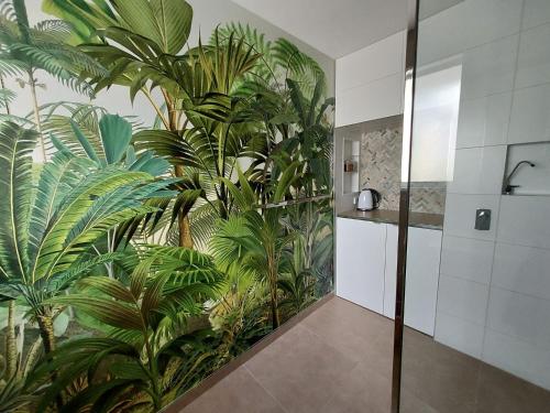 a bathroom with a mural of plants on the wall at Hawaiian Escape on the Sunshine Coast, pet friendly in Alexandra Headland