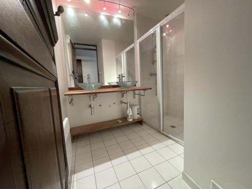 a bathroom with two sinks and a walk in shower at Saint marty in Montory
