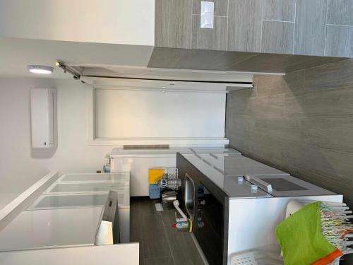 a kitchen with a sink and a counter top at Bungalow enfrente piscina en Maspalomas in Maspalomas