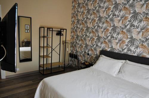 a bedroom with a white bed and a floral wallpaper at Guest House Prime Palace in Rome