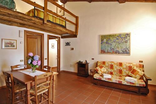 a living room with a couch and a table at Venturo Agriturismo Restaurant & Horses in Castelnuovo di Garfagnana