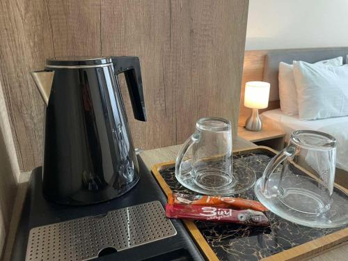a coffee maker and glasses on a kitchen counter at Galaxy Apartments in Belgrade