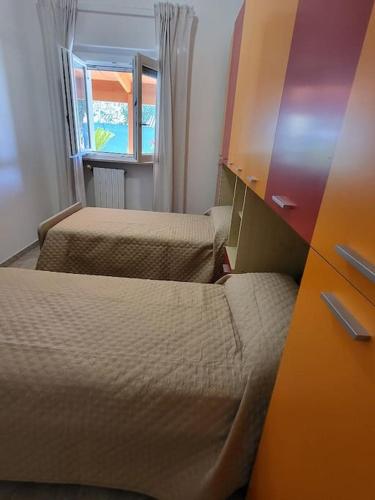 a small room with two beds and a dresser at Dimora da Capo Appartamento in Villa in Casoli